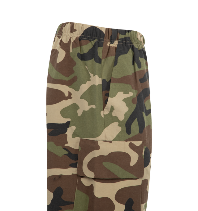 Image 3 of 3 - GREEN - Fear of God Essentials Military Field Pants are designed in camouflage nylon-viscose with a perforated lining, cargo pockets, an elastic drawstring waist, side pockets, and ankle bungees.  