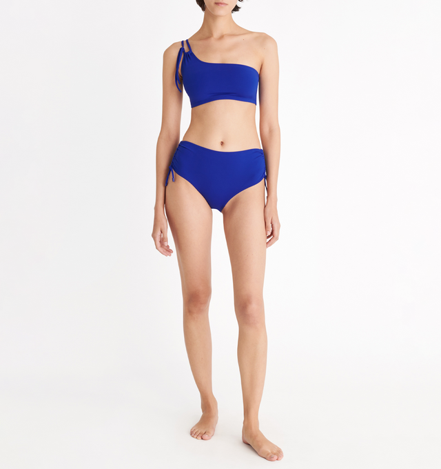 Image 3 of 6 - BLUE - ERES Bass One-Shoulder Bikini Top featuring one-shoulder bikini top, double adjustable and sliding spaghetti strap with branded tips and slips on and off. 84% Polyamid, 16% Spandex. Made in Morocco.  