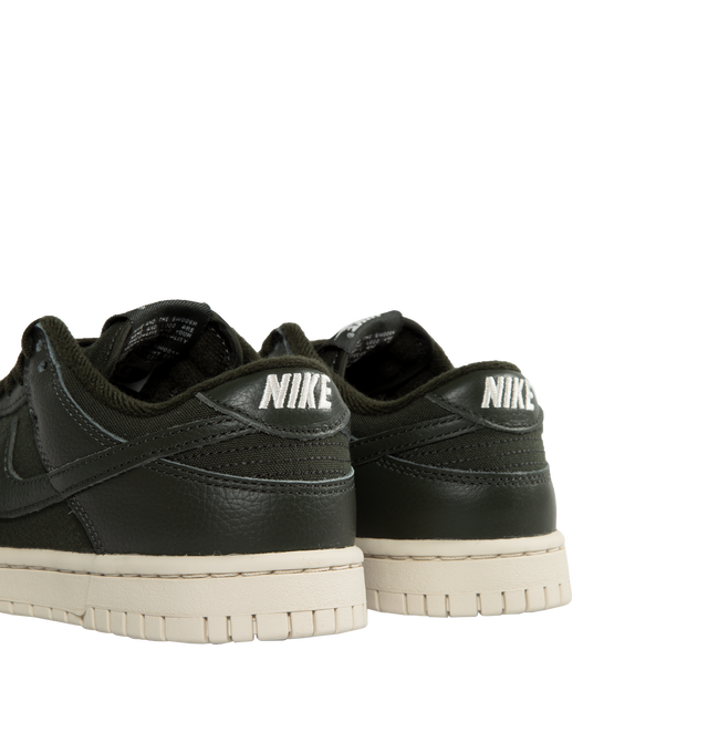 BLACK - NIKE Dunk Low Retro PRM Sneakers featuring subtle distressing throughout, lace-up closure, logo patch at padded tongue, padded collar, swoosh appliqu� at sides, logo embroidered at heel tab, mesh lining, crepe rubber midsole and treaded rubber outsole. Made in Viet Nam.