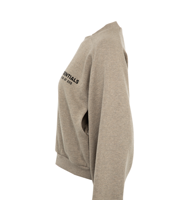 Image 3 of 3 - GREY - Fear of God Essentials Womens cropped crewneck sweatshirt in a pullover style with long sleeves, two slip pockets at front, embossed brand print at front and back, and ribbed trims. 80% cotton, 20% polyester.  