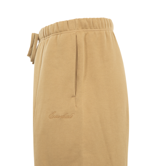 Image 3 of 3 - BROWN - FEAR OF GOD ESSENTIALS Signature Lounge Sweatpant featuring heavy 480GSM core fleece, oversized silhouette, Essentials signature logo embroidered on the leg, front leg seam, encased elastic waistband with elongated drawcords, side-seam pockets and an Essentials signature label at the center front. 80% cotton, 20% polyester. 