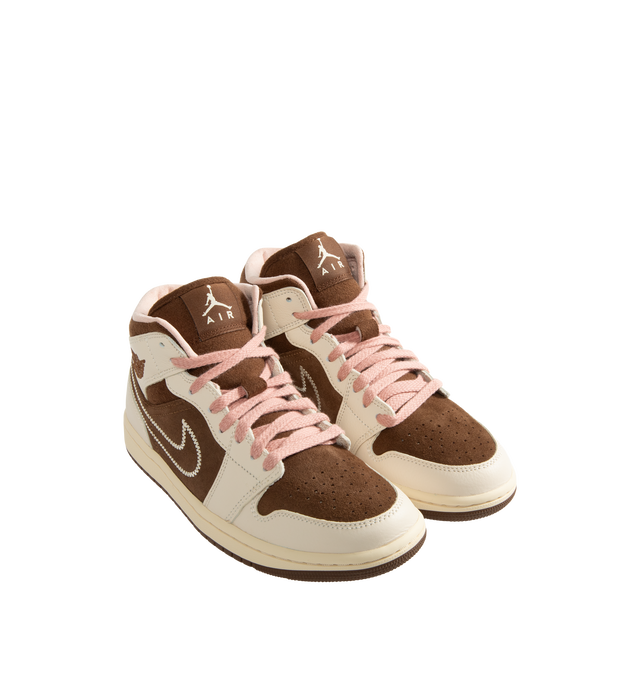 Image 2 of 5 - BROWN - Air Jordan 1 Mid Women's Shoes feature the iconic basketball-inspired silhouette and combine premium comfort with everyday wearability. Crafted with a durable leather upper, this classic style is equipped with an encapsulated Nike Air-Sole unit and a foam midsole for lightweight cushioning, while a rubber outsole provides reliable traction. Finished with a padded collar and traditional lace-up closure, the AJ1 Mid delivers timeless Jordan heritage with lasting support. Main Material:  