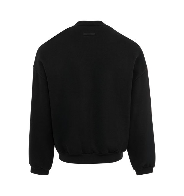 Image 2 of 2 - BLACK - Fear of God Essentials Black Heavy Fleece Crew Neck Sweatshirt crafted from 100% heavy cotton fleece featuring a crew neckline, long sleeves with dropped shoulders, side seam pockets, a rubber brand label at the upper back, and a Fear of God A&M satin applique on the front.  