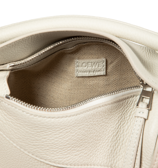 Image 3 of 3 - WHITE - LOEWE Small Puzzle bag featuring removable and adjustable shoulder strap, zip closure with calfskin pull, exterior zip rear pocket and one internal slip pocket, herringbone cotton canvas lining and embossed Anagram. 6.5 x 9.4 x 4.1 inches. 100% Soft Grained Calf. Made in Spain. 