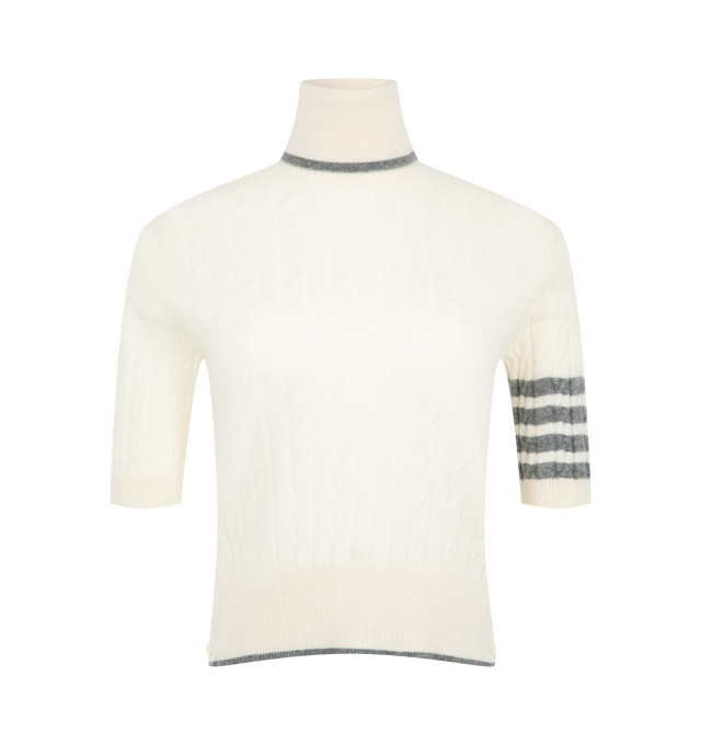 Image 1 of 2 - WHITE - Thom Browne Women's Cashmere 4-Bar Baby Cable Stitch Turtleneck is crafted from luxurious cashmere and features a delicate baby cable stitch construction accented by the brands signature engineered 4-bar detail. Designed with a ribbed foldover turtleneck and hem with contrast tipping, the knit is finished with ribbed cuffs, buttoned side vents with internal RWB grosgrain trim, and Thom Brownes signature striped grosgrain loop tab. Main Material: 100% Cashmere. Made in Italy. 