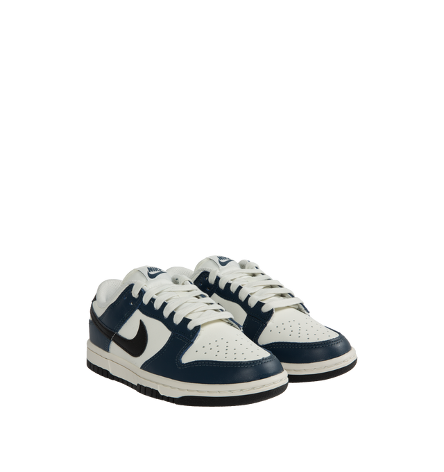 Image 2 of 5 - BLUE - Nike Dunk Low Sneakers with white and midnight navy color-blocking with a black swoosh,  a padded, low-cut collar, leather upper with a slight sheen and durability, foam midsole offering lightweight, responsive cushioning. Perforations on the toe add breathability. Rubber sole with classic hoops pivot circle provides durability and traction. 
