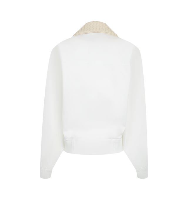 Image 2 of 3 - WHITE - Bottega Veneta Women's Cotton Blouson is crafted from lightweight water-repellent cotton and features a relaxed silhouette with an Intrecciato leather collar, a detachable Intrecciato leather throat latch, and a zip-and-button front closure. Fully lined for added comfort, this designer jacket combines signature Bottega Veneta craftsmanship with functional outerwear details, creating a refined everyday layering piece. Main Material: 100% Cotton. Made in Italy. 