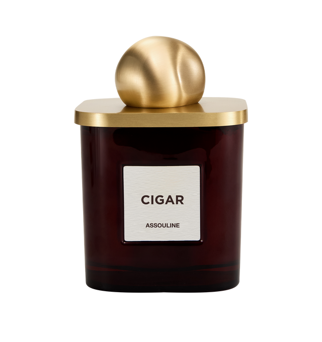 Image 3 of 3 - RED - Assouline Library Candle  Cigar is a luxury scented candle that captures the warm, sophisticated ambiance of a Havana lounge with an oriental fragrance blending cedar, clove, patchouli, amber, and tonka bean. Housed in a heavyweight amber glass vessel with a textured paper label, this designer candle is crafted from a premium soy, coconut, and paraffin wax blend for a clean, even burn and exceptional scent throw. Top Notes: Allspice, Damask Rose. Heart Notes: Jasmine, Cedarwood. Base No 