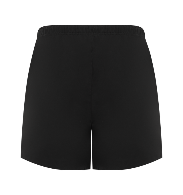 Image 2 of 3 - BLACK - Fear of God Essentials Mens Gym Shorts are crafted from polyester. Feature a relaxed mid-length fit, perforated stretch lining, elasticized waistband with bungee drawcord and toggle, side pockets, puff-printed FGE and F26 graphics, and an Essentials logo label. Main Material: 100% Polyester. 