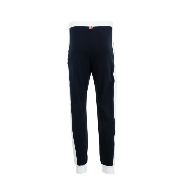 Image 2 of 3 - NAVY - Thom Browne ultra-comfortable sweatpants made from breathable cotton fabric.Pull-on style featuring drawstring waistband with silver tone aglets, side slip pockets, name tag applique, signature striped grosgrain loop tab. 100% Cotton. Made in Japan. 