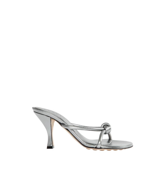 Image 1 of 4 - SILVER - BOTTEGA VENETA Blink Metallic Sandal featuring tubular straps of lambskin leather interlaced to the label's signature knot, asymmetric toe, pebbled rubber sole, cushioned footbed, leather upper and rubber sole. 95mm. Made in Italy. 