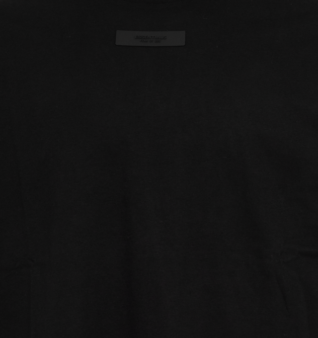 Image 2 of 2 - BLACK - FEAR OF GOD ESSENTIALS Crewneck T-Shirt featuring rib knit crewneck, rubberized logo patch at chest and back, dropped shoulders and dolman sleeves. 100% cotton. Made in Viet Nam. 