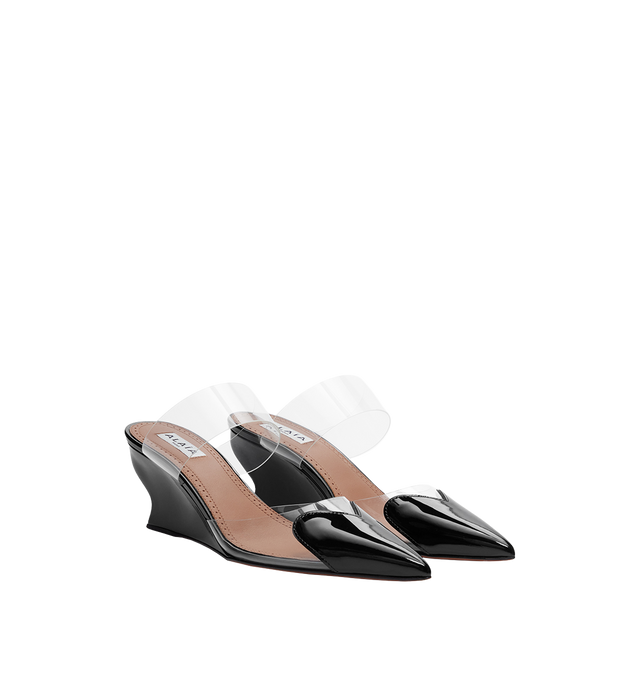 Image 1 of 1 - BLACK - Alaa Womens Heart Cut Wedge Mules are crafted from patent leather and transparent polyurethane. Features the signature heart cut at the front, 60 mm wedge heel, and slip-on styling. Main Lining: 100% Lambskin Leather; Sole: 80% Calfskin Leather, 20% Rubber; Upper Material 1: 100% Polyurethane; Upper Material 2: 100% Calfskin Leather; Heel: 100% Calfskin Leather. Made in Italy. 