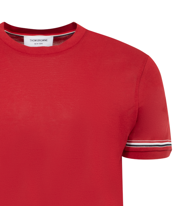 Image 2 of 2 - RED - THOM BROWNE Striped Sleeve Tee featuring bound crew neckline, name tag applique above hem, button side vents with signature grosgrain trim, grosgrain trim at sleeves and signature striped grosgrain loop tab. 100% cotton. Made in Italy. 