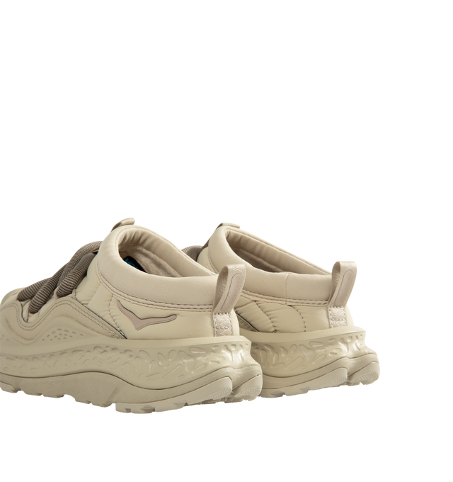 Image 3 of 5 - NEUTRAL - Hoka Unisex Ora Primo Sneaker featuring soft knit collar, insulated puff upper, slip-on style, zig-zag stitch detail, round elastic lace system and protective toe bumper. Nylon, textile. Rubber sole. *Unisex style in men's sizing.  