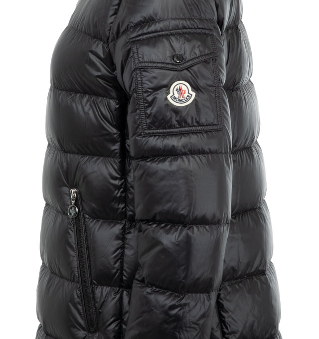 Image 3 of 3 - BLACK - Moncler Glements Short Parka has an attached hood, a 2-way zip closure, an inner front flap, front zip pockets, a sleeve flap pocket with a snap button, ribbed cuffs, and a logo detail. Lined.  