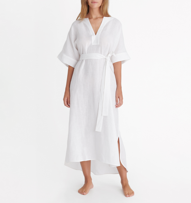 Image 2 of 4 - WHITE - ERES Bibi Kaftan featuring short sleeves, V-neckline, pleated back, removable belt without loop, rounded slits on each side at the bottom and length above ankles. 100% Linen. Made in Bulgaria. 