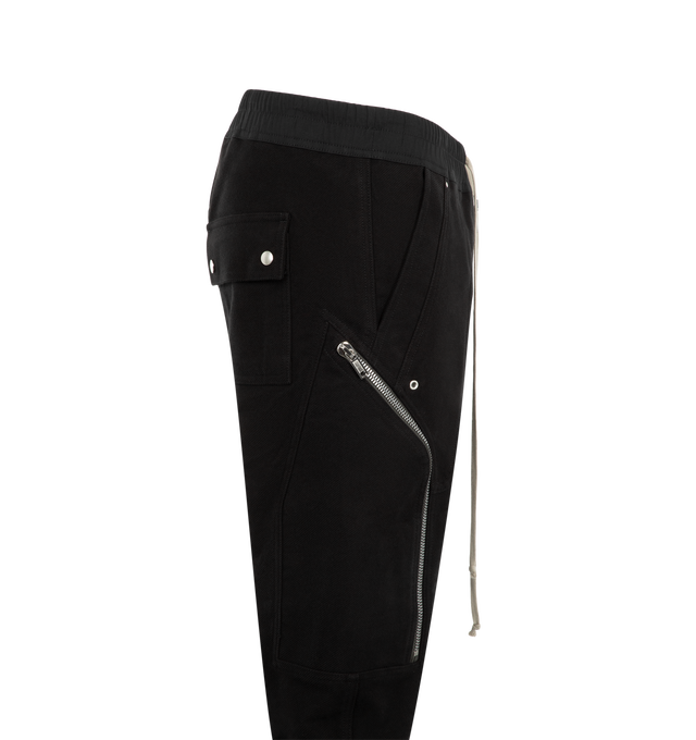 Image 3 of 3 - BLACK - Rick Owens Mens Heizer Cargo Pants are crafted from cotton poplin. Feature a slim fit, elasticized waistband with drawstring, exposed Bela front zip closure with snap detail, angled zip cargo pockets, front shin zip openings, elasticized cuffs, side welt pockets, back flap pockets with snap closures, and double topstitch detailing. Main Material: 97% Cotton, 3% Elastane. Made in Italy. 