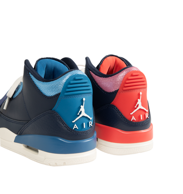 Image 3 of 5 - NAVY - Jordan Women's Air Jordan 3 Retro "Sport Renaissance" Sneakers feature an Obsidian, Track Red, and Chalk upper crafted from leather and synthetic leather. The classic silhouette is finished with a foam midsole, visible Max Air cushioning, and a rubber outsole. Upper: Leather and Synthetic Leather. Midsole: Foam. Sole: Rubber. 