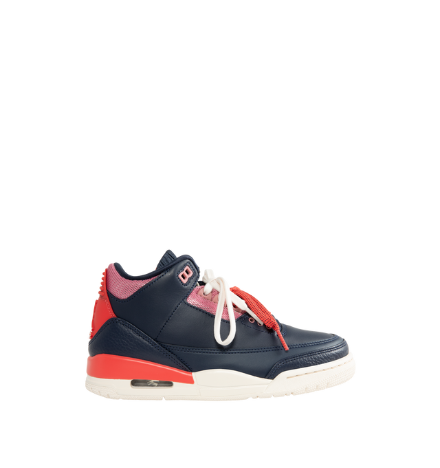 Image 1 of 5 - NAVY - Jordan Women's Air Jordan 3 Retro "Sport Renaissance" Sneakers feature an Obsidian, Track Red, and Chalk upper crafted from leather and synthetic leather. The classic silhouette is finished with a foam midsole, visible Max Air cushioning, and a rubber outsole. Upper: Leather and Synthetic Leather. Midsole: Foam. Sole: Rubber. 