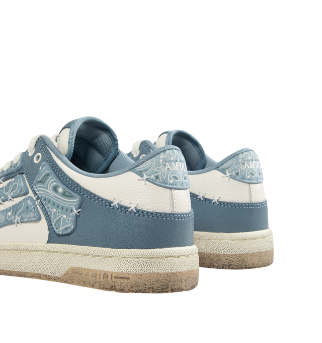 Image 3 of 5 - BLUE - AMIRI Bandana Skel Top Low Sneakers featuring low-top, buffed leather, logo pattern embossed throughout, perforated detailing at toe, lace-up closure, logo patch at padded tongue, padded collar, bandana print appliqus at sides and treaded rubber sole. Upper: leather. Sole: rubber.  