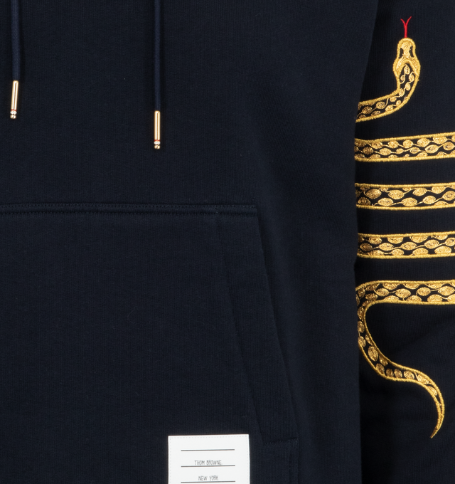 Image 3 of 3 - NAVY - Thom Browne Men's Lunar New Year Snake Embroidery Hooded Pullover Sweatshirt featuring slouchy drawstring hood, long sleeves, front pouch pocket, logo patch to the front, ribbed cuffs and hem and signature grosgrain loop tab. 100% Cotton. Made in Italy. 