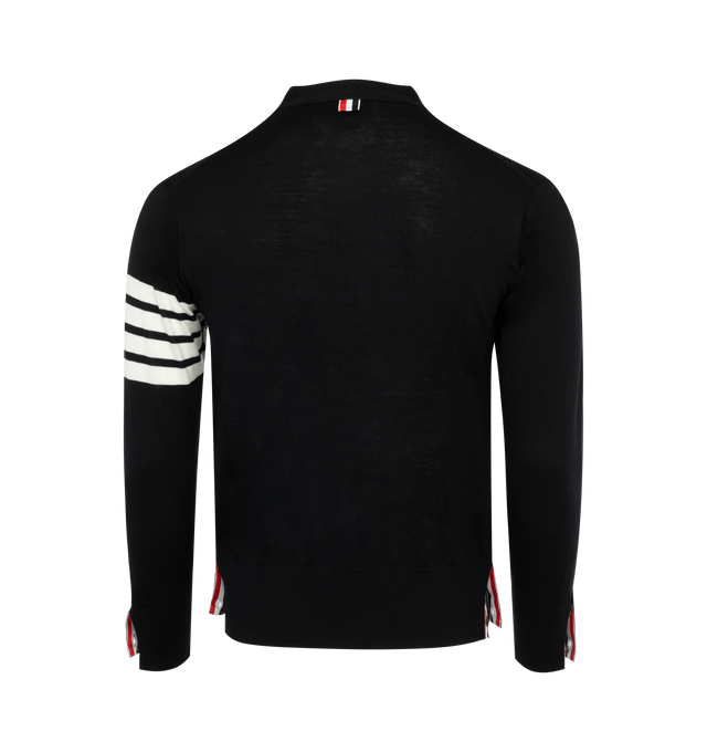 BLACK - THOM BROWNE long sleeve knit merino wool cardigan with ribbed collar, cuffs, and hem. Button closure featuring concealed signature tricolor grosgrain trim at front. Welt pockets at waist. Signature stripes in white at sleeve. 100% Merino Wool.