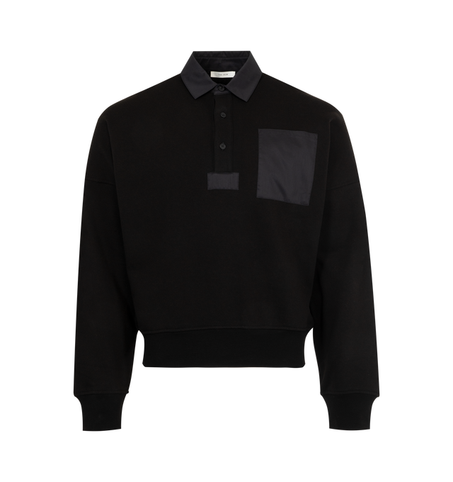 Image 1 of 2 - BLACK - THE ROW Dende Top in Cotton and Cashmere featuring oversized polo top in french terry with dropped shoulders, tonal cotton patch pocket, collar, and placket square, and ribbed cuffs and hem. 84% cotton, 16% cashmere. Made in Italy. 