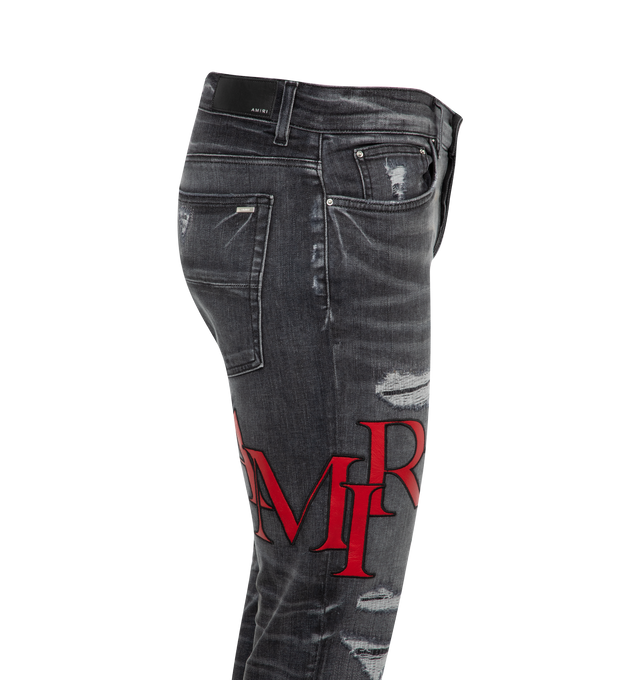 Image 3 of 3 - GREY - AMIRI Staggered Logo Skinny Jeans featuring regular rise, five-pocket style and fitted through skinny legs. Cotton/polyester/elastane. Made in USA. 