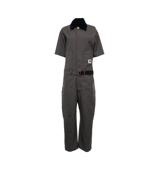 GREY - SACAI X CARHARTT WIP Suiting Bonding Jumpsuit is a hybrid of Carhartt WIPs Bib Overall, and sacais short-sleeve suit shirt and trousers. The item is constructed from two bonded layers of fabric and can be worn inside-out. On the surface is sacais wool-blend suiting fabric and on the reverse is Carhartt WIPs duck canvas. A chest pocket belonging to sacais short-sleeve suit shirt appears on the outside, with stitched details appearing on the reverse. The surface also features sacais suit pant pockets, 