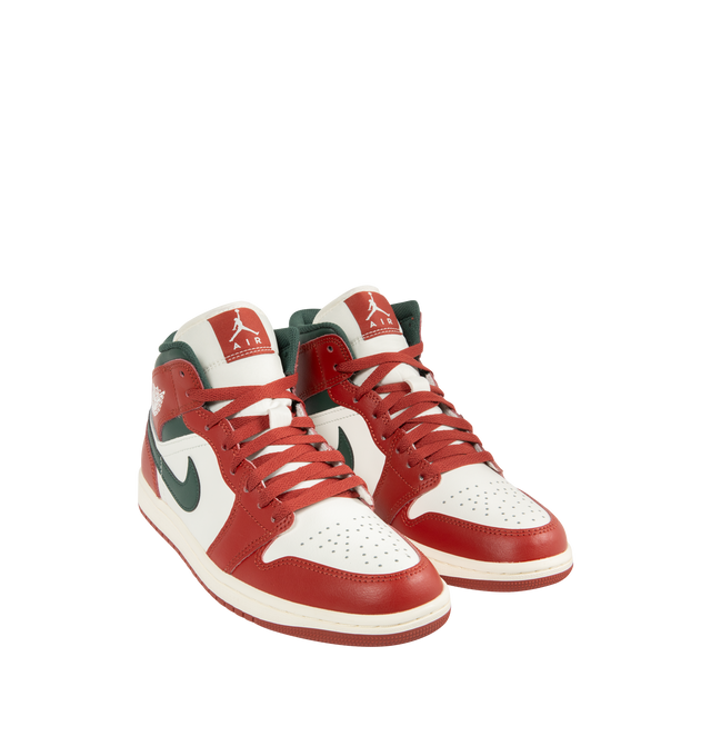 Image 2 of 5 - RED - JORDAN Air Jordan 1 Mid Sneaker featuring mid-top, leather, synthetic leather, textile upper, foam midsole, Nike Air cushioning and rubber outsole with pivot circle. 