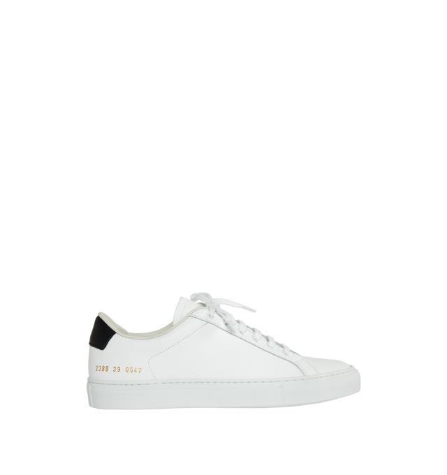 Image 1 of 5 - WHITE - Common Projects  Retro Classic Leather Lace-Up Sneakers in a minimal design crafted from white calf leather with black leather tabs at the heels, detailed with signature gold stamped serial numbers. 