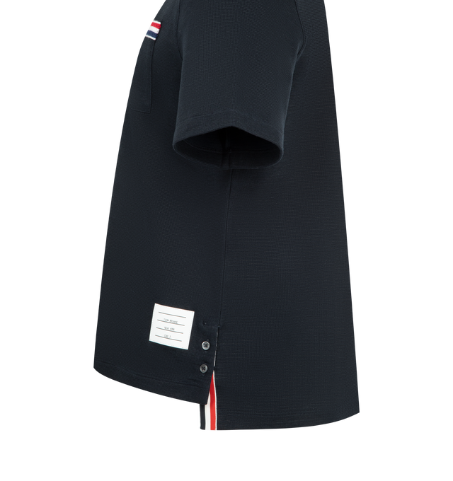 Image 3 of 3 - NAVY - THOM BROWNE Textured Cotton Linen Tee featuring a cotton-linen blend, waffled exterior, ribbed neckline, patch chest pocket with knit RWB trim, buttoned side vents with RWB grosgrain trim, stepped hem, name tag appliqu and signature striped grosgrain loop tab. 55% cotton, 36% linen, 7% polyamide, 2% elastane. 
