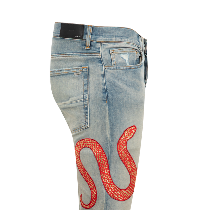 Image 3 of 3 - BLUE - Amiri Snake Skinny Jeans are a 5-pocket style with hand-distressing and designed with the brand's signature applique snake motif. Made in USA.  