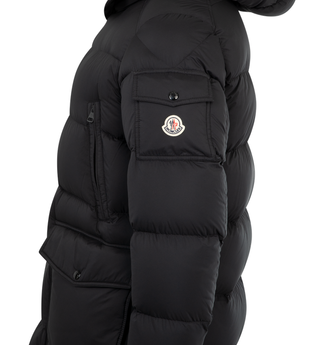 Image 3 of 3 - BLACK - MONCLER Bretagne Hooded Short Down Jacket featuring water-repellent main fabric, longue saison lining, down-filled, adjustable hood, zipper and snap button closure, chest pockets with zipper closure, patch pockets with snap button closure, sleeve pocket with snap button closure, inside zipped pocket, waistband with drawstring fastening and adjustable cuffs. 100% polyamide/nylon. Padding: 90% down, 10% feather. Made in Romania. 