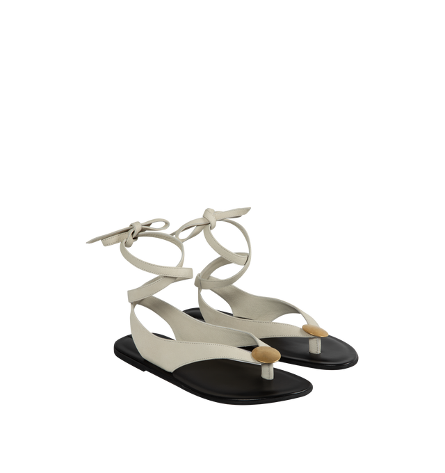 Image 2 of 4 - GREY - The Row wrapped thong sandal in soft nubuck leather with metal circular charm, hand-stitched detailing, and polished leather insole. 100% Leather with rubber sole.Made in Italy. 