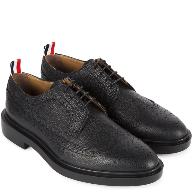 Image 2 of 2 - BLACK - Thom Browne Longwing Brogue have an elongated toe, a lace-up closure, perforation details, signature grosgrain loop tabs, and tonal rubber soles. 100% calf leather. Made in Italy.  