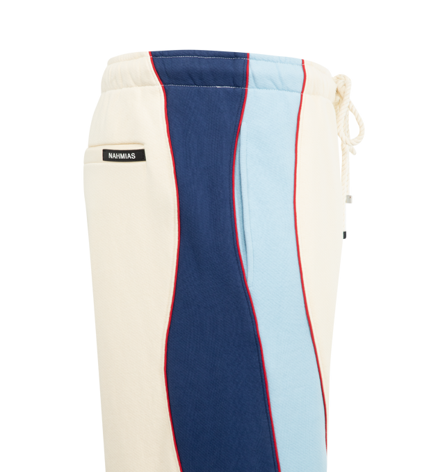 Image 3 of 3 - WHITE - NAHMIAS Ollie Sweatpants featuring elastic waist with drawstring, side pockets, two back welt pockets, logo on leg, stripes and piping down leg, loose fit and bungee cord at hem. 100% cotton.  