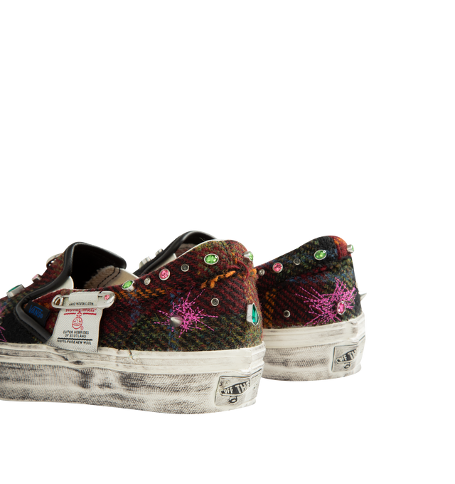 Image 3 of 5 - MULTI - Vans Unisex Premium Classic Harris Tweed Slip-On Sneakers are crafted from Harris Tweed woven from 100% virgin wool and feature the brand's iconic laceless slip-on silhouette, elastic side panels, and a padded collar for enhanced comfort. Designed with jewel, pin, and stud embellishments, contrast stitching, and a subtly distressed finish. Main Material: Harris Tweed 100% Virgin Wool. Outsole: Rubber. Details: Jewel, Pin, and Stud Embellishments. *Unisex style in men's sizing. 