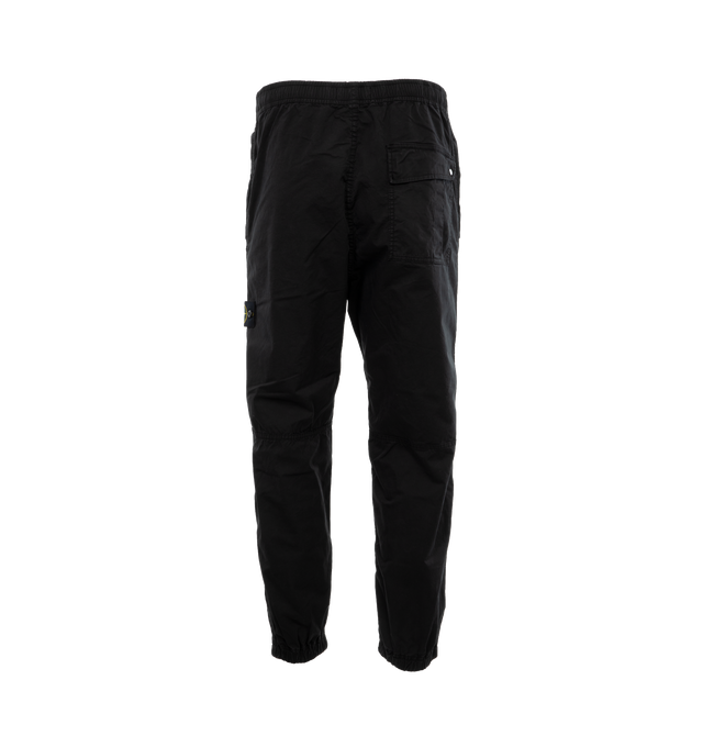 Image 2 of 4 - BLACK - STONE ISLAND Loose-Fit Cargo Pants featuring slanting hand pockets with slanted shaped flap and snap fastening, one patch bellows pocket on the back with shaped flap fixed on one side with a snap on the other side, big patch bellows pocket on the left leg, fixed on one side, snap on the other side, Stone Island badge, elasticized leg bottom and elasticized waistband with inner drawstring. 97% cotton, 3% elastane/spandex. 