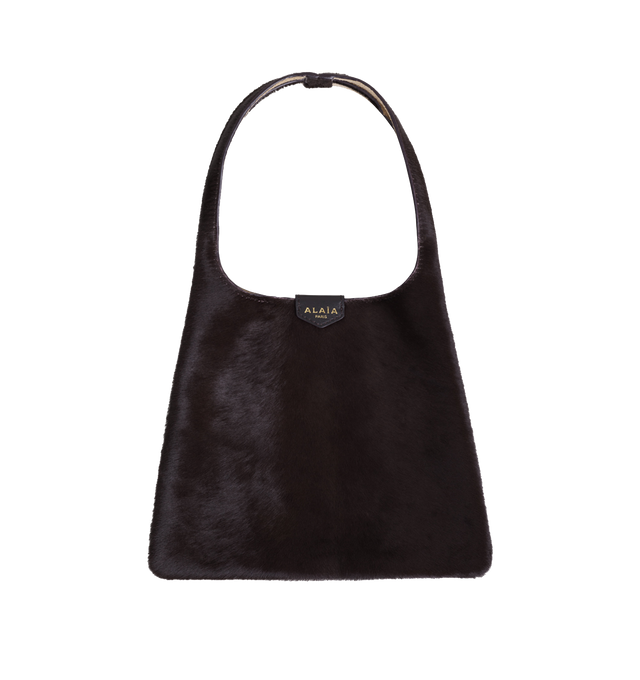Image 1 of 1 - BROWN - Alaa mini hobo bag crafted in haircalf with a timeless silhouette designed to complement a wide range of looks. The compact shoulder bag features a sleek, curved shape and comes in a rich chocolate hue, offering an elegant everyday accessory. Fits all your small daily essentials including a phone, card holder, keys, sunglasses, and other small personal items. Dimensions (cm): L 32 x H 21 x D 2.  Made in Italy. 