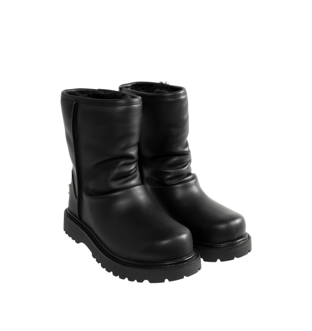 Image 2 of 4 - BLACK - UGG x Willy Chavarria Relaxed Boot is crafted from leather and features a mid-calf silhouette inspired by classic motorcycle boots. Designed as a slouchier interpretation of the biker boot, it is detailed with custom chrome logo hardware, a draped black leather upper, and a soft sheepskin-lined interior that combines rugged styling with signature comfort. Main Material: Leather. Lining: Sheepskin. Unisex style in men's sizes. 