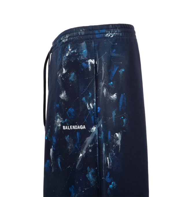 Image 3 of 3 - NAVY - Balenciaga Men's Paint Splatter Baggy Sweatpants are crafted from faded black dry cotton fleece and feature a mid-rise, oversized silhouette. An elasticated drawstring waistband, and Balenciaga artwork at the front complete the design. Main Material: 100% Cotton. Pocket Lining: 100% Cotton. Made in Portugal. 