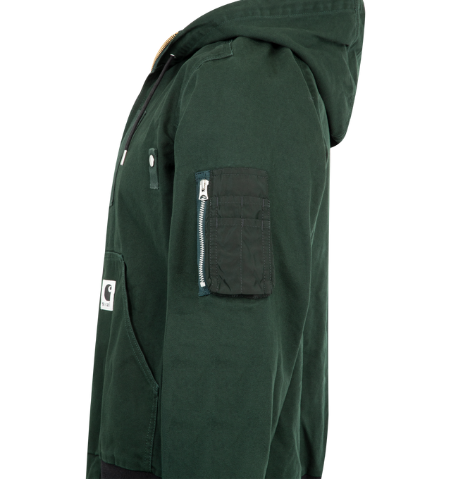 Image 3 of 3 - GREEN - SACAI X CARHARTT WIP Washed Duck Hooded Jacket featuring drawstring hood, drop shoulders, long sleeves, sleeve zip pocket, split kangaroo pocket, rib-knit trim and two-way front zip closure. 100% cotton. 100% nylon. Made in Japan. 