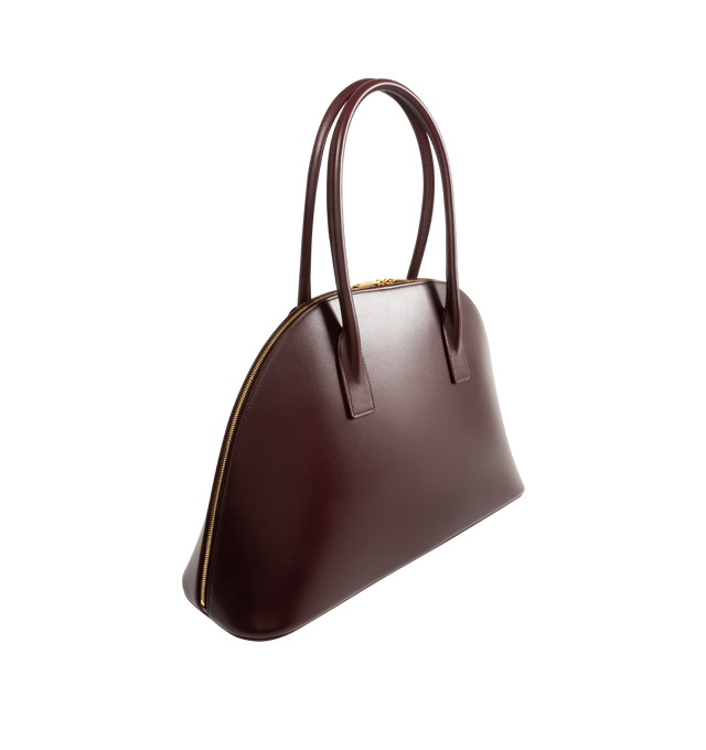 Image 2 of 3 - RED - SAINT LAURENT Sac De Jour Duffle featuring half-moon shape, full zip closure, elongated straps, providing both hand and shoulder carry options, leather lining, bronze-tone hardware, one zip pocket and five metal feet. 16.5" x 10.8" x 0.84.7". Calfskin leather. Made in Italy. 