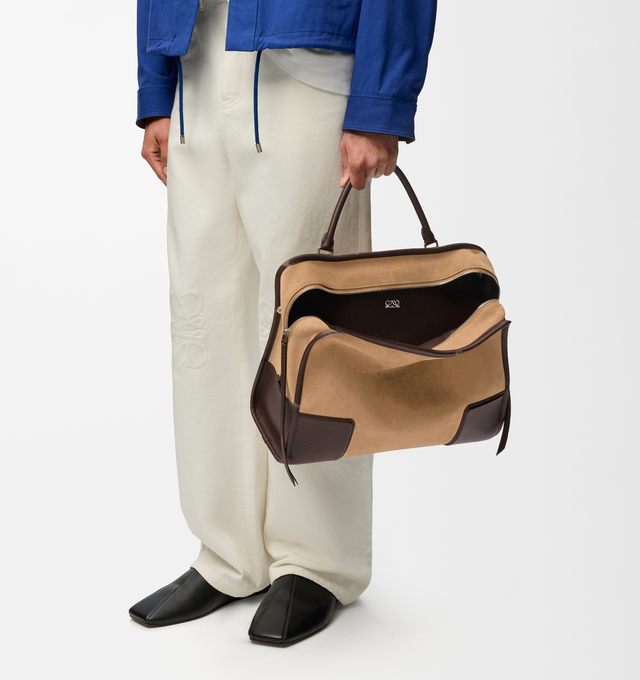 Image 2 of 16 - BROWN - Loewe Mens Amazona 180 XL Bag is crafted from suede with soft calfskin details. Features a relaxed silhouette, single toron top handle, removable shoulder handle, adjustable crossbody strap, zip closure with two leather pullers, two compartments with concealed magnetic closure, interior flat pocket, side D-ring, suede and nappa lambskin lining, palladium-tone hardware, and embossed LOEWE and Double L branding. Dimensions: 40  31  16 cm; Strap Length: 105133 cm; Strap Drop: 4761 cm; H 
