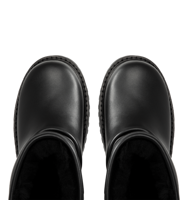 Image 4 of 4 - BLACK - UGG x Willy Chavarria Relaxed Boot is crafted from leather and features a mid-calf silhouette inspired by classic motorcycle boots. Designed as a slouchier interpretation of the biker boot, it is detailed with custom chrome logo hardware, a draped black leather upper, and a soft sheepskin-lined interior that combines rugged styling with signature comfort. Main Material: Leather. Lining: Sheepskin. Unisex style in men's sizes. 