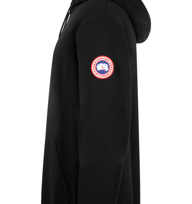 Image 3 of 3 - BLACK - Canada Goose Men's Loon Hoodie combines softness with a classic silhouette designed for comfortable everyday wear. This designer hoodie is finished with Canada Goose's signature Classic Disc logo for an iconic brand detail. Details: Pull-over, Hood, Front Pocket, Classic Canada Goose Disc. Logo Main Material: Cotton. 