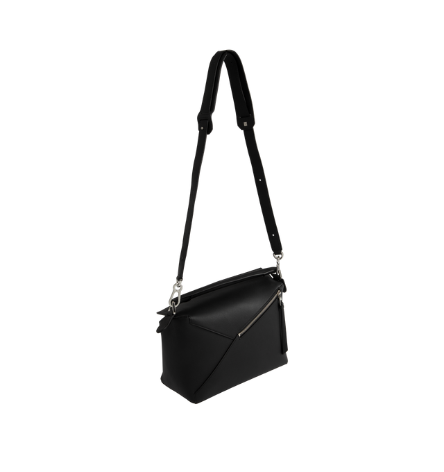 Image 2 of 3 - BLACK - Loewe Medium Puzzle Edge bag in soft grained calfskin featuring a cuboid shape and precise cutting technique to create Puzzles distinctive geometric lines. Shoulder, crossbody or hand carry with a detachable and adjustable strap, top handle. Featuring zip closure with calfskin pull, herringbone cotton canvas lining, embossed Anagram.  Height 7.7" X Width 11.4" X Depth 5.5". Made in Spain. 