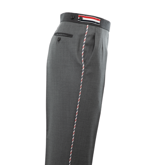 Image 3 of 4 - GREY - THOM BROWNE Funmix Super 120s Twill Trouser featuring tab closure, flat front, creased legs, wide cuffs, slant side pockets, button-fastening back welt pockets, adjustable buttoned side straps and signature striped grosgrain loop tab at back waist. 100% wool.  